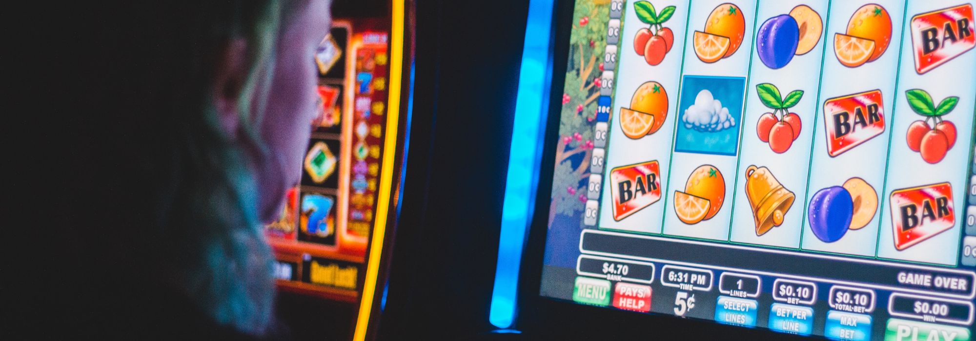 A woman playing the pokie machines